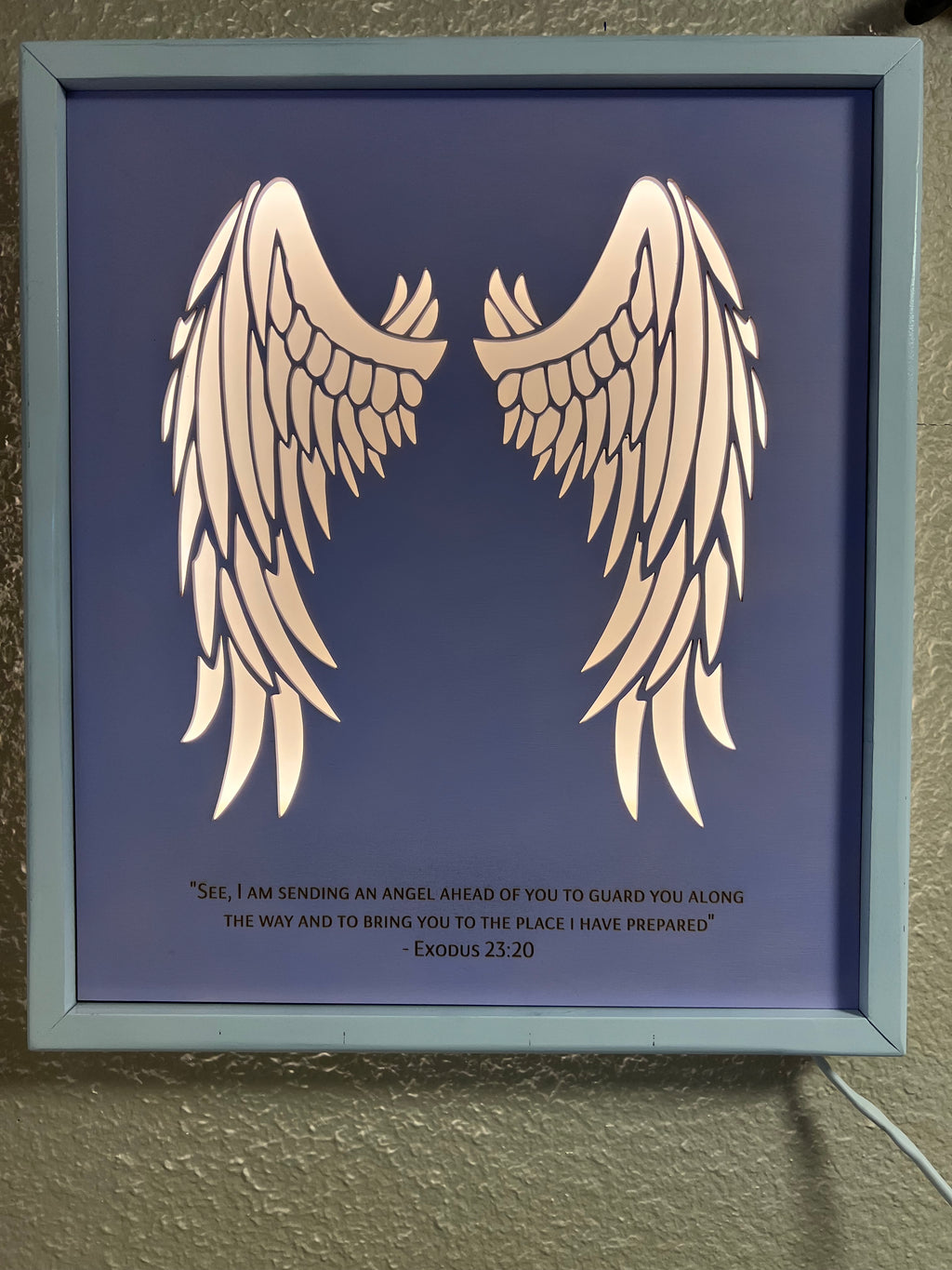 Angel wings wall decor with inscription and LED lighting