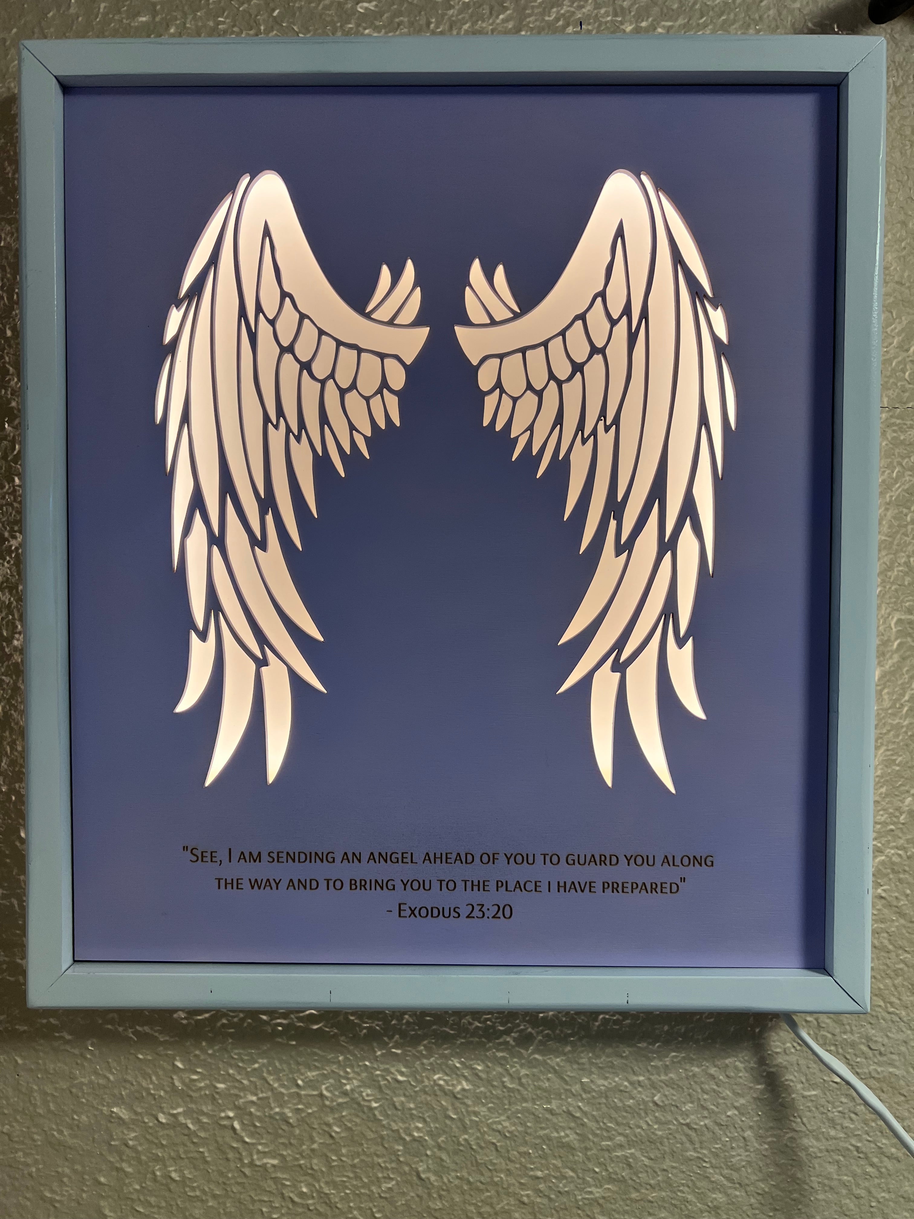 Angel wings wall decor with inscription and LED lighting