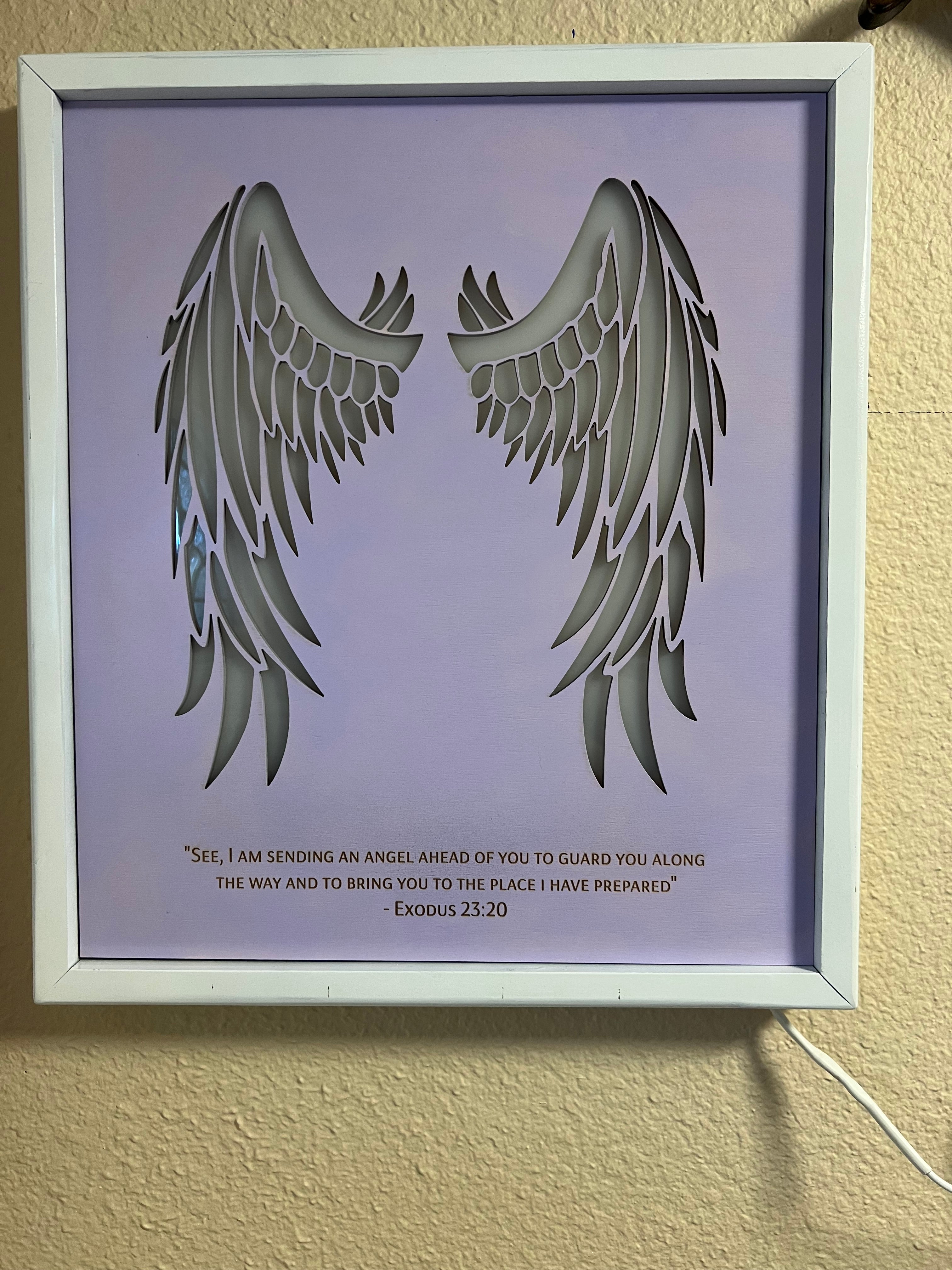 Angel wings wall decor with inscription and LED lighting
