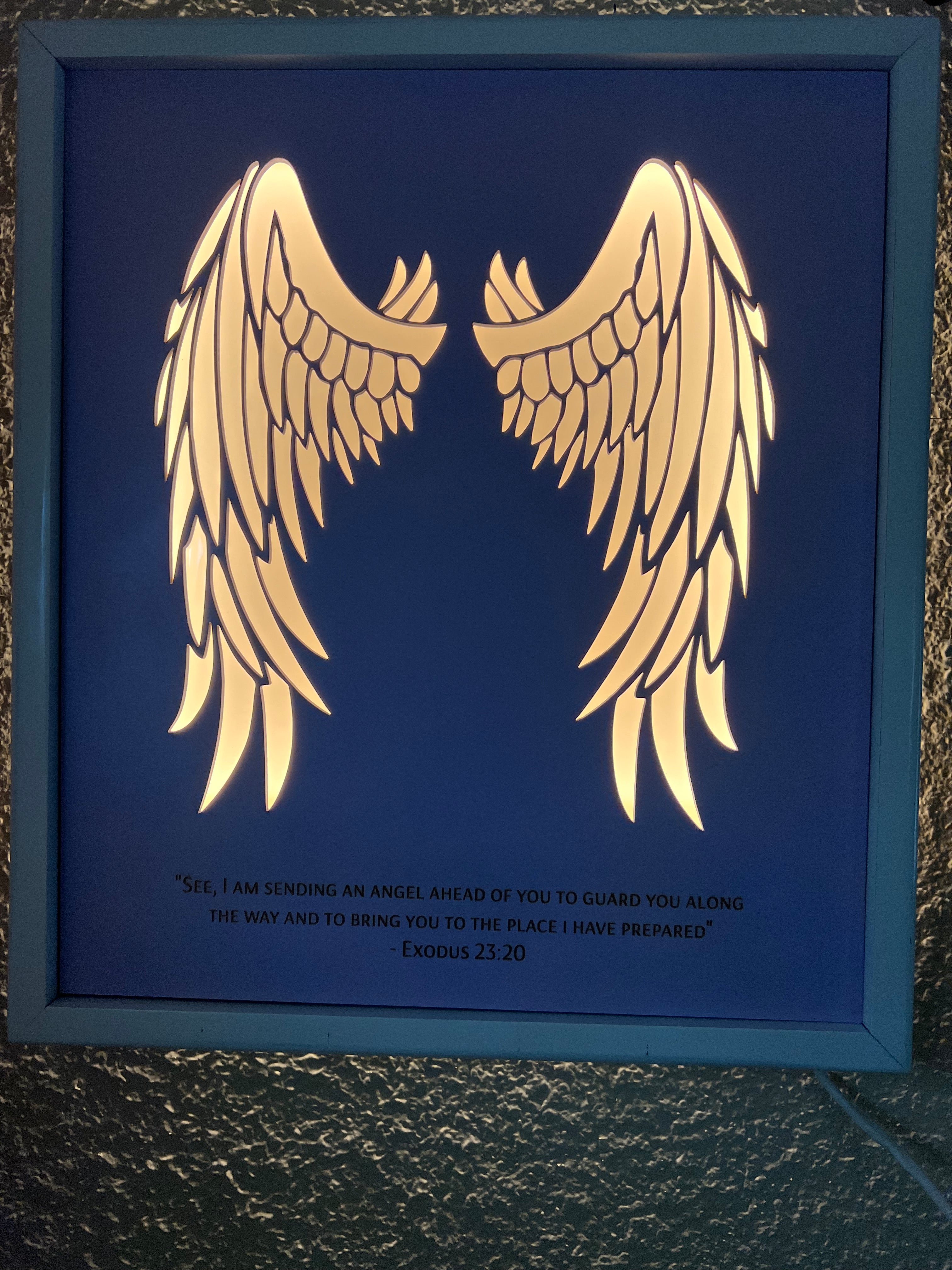 Angel wings wall decor with inscription and LED lighting