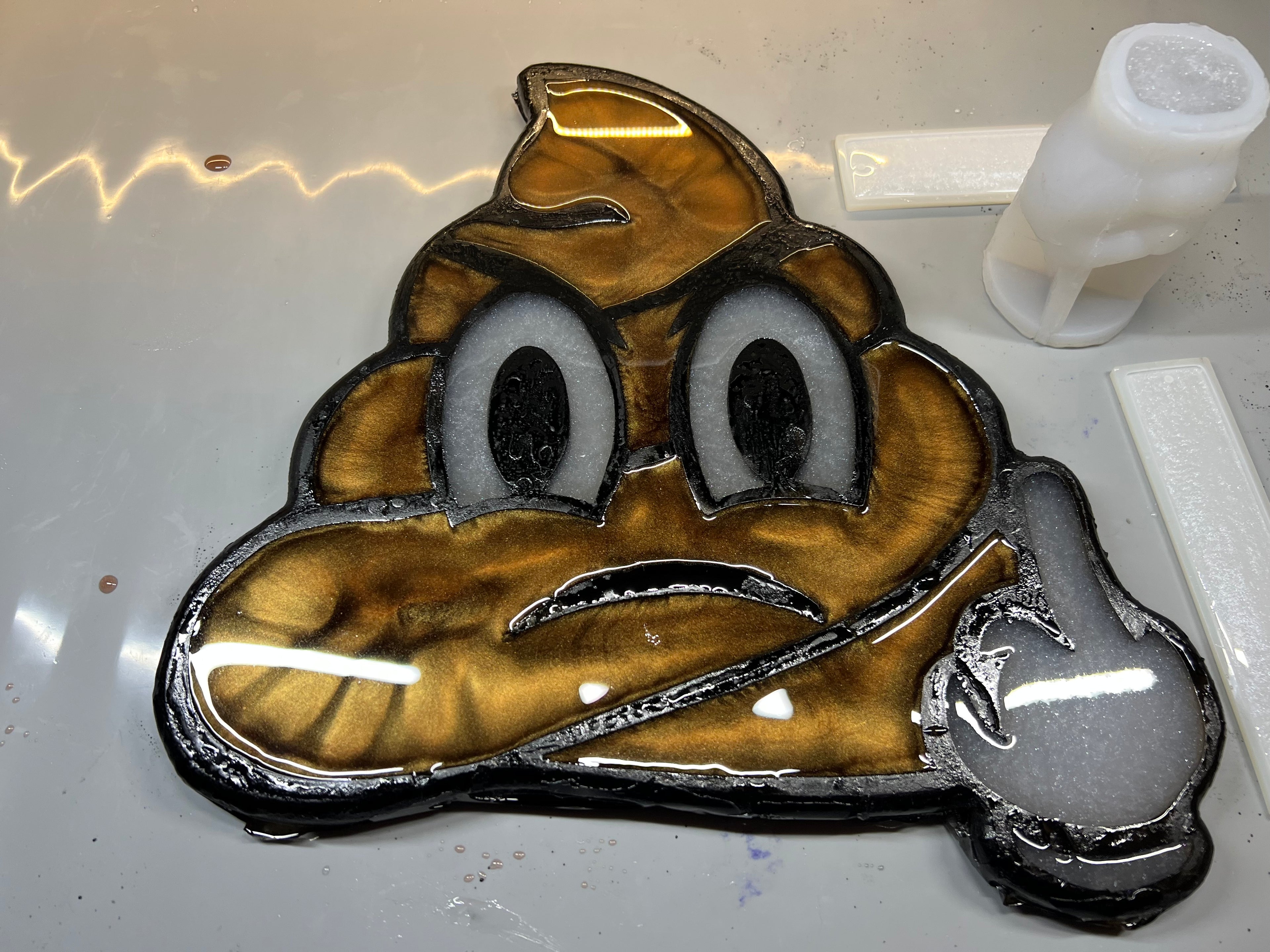 Poo emoji finger